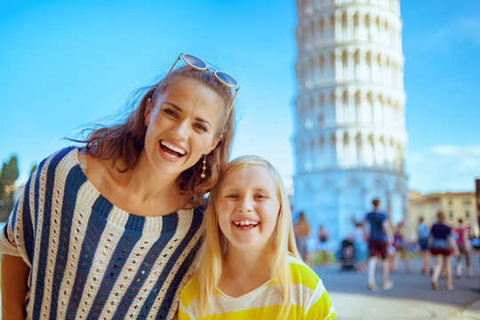 mother and daughter standing in front of leaning tower in Pisa