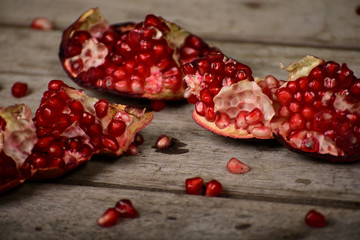 Juicy pomegranate on wooden background