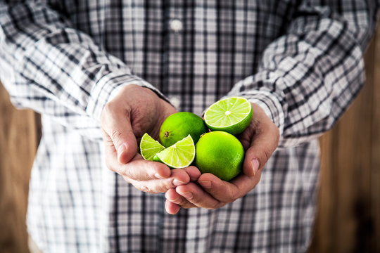 Man holding limes.