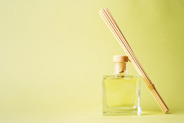 Aroma reed diffuser home fragrance with rattan sticks with glass bottle. Tropical green mood blank...