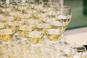 catering services. glasses with white wine champagne in several rows and three layers at restaurant party