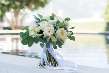 wedding bouquet of white roses and greenery