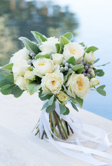wedding bouquet of white roses and greenery
