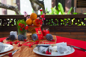 Chinese New Year party table in red and gold theme with food, drinks and decorations