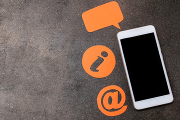 client support service. Contact us for feedback. desktop with a smartphone and various feedback icons. top view