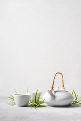 Asian food background set with  green tea, cups and teapot with free space for text on white...