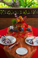 Chinese New Year party table in red and gold theme with food, drinks and decorations