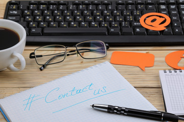 client support service. Contact us for feedback. desktop with notepad and various feedback icons.