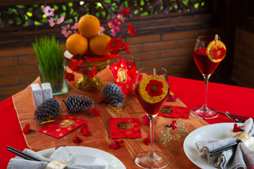 Chinese New Year party table in red and gold theme with food, drinks and decorations