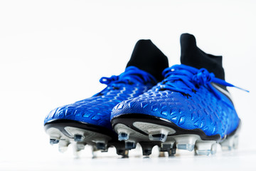Pair of football soccer boots cleats shoes on a white background. Frame Football theme with copy...