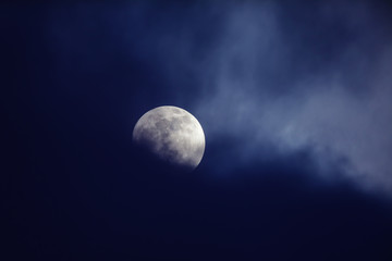 Naklejka na ściany i meble Moon on night sky against dark clouds