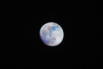 Color Moon on night sky. Natural colors of our satellite emphasized in postproduction