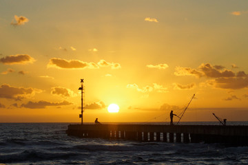 Fototapeta na wymiar fishers in the sunset