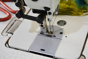 Sewing machine on table in tailor's workshop