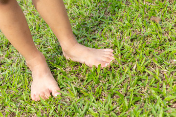 Baby's foot stepping on the grass.