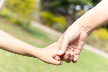 Mother and son holding hand.