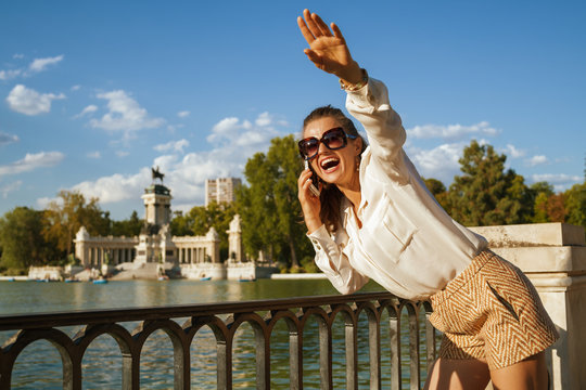 smiling traveller woman using smartphone and waving for someone