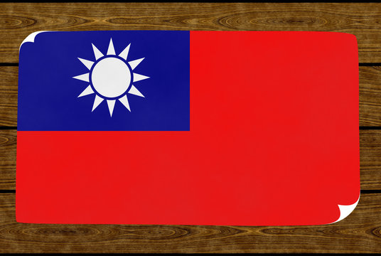Illustration of a Taiwanese flag on the paper pasted on the woody wall