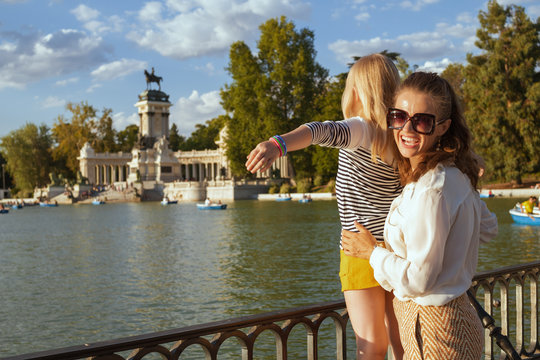 happy mother and child tourists at Park del Retiro rejoicing