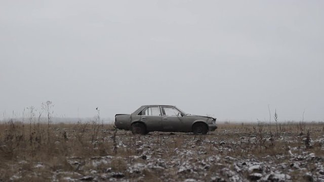 Old car thrown into the field, Side View