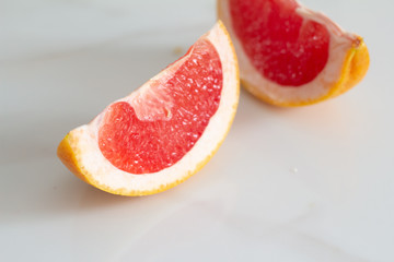 Fototapeta na wymiar slice of pink grapefruit closeup on white background.