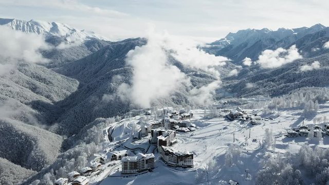 Rosa Khutor ski resort, Sochi, Krasnaya Polyana. Winter forest, nature of the Caucasus, hotel on the banks of the river Mzymta. Aerial photography with quadcopter