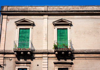 Balcony in a historic building in Catania, traditional architecture of Sicily, Italy