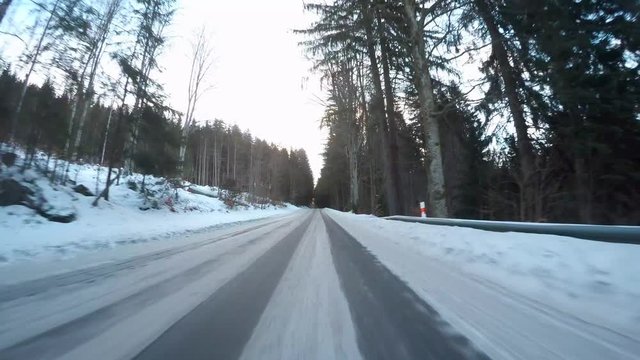 Snowy road. Dangerous situation from winter traffic in National park Sumava, Czech Republic, Europe. Video from action camera with engine sound.