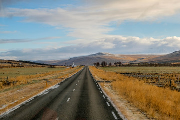 Long Road in iceland with mounrtain background