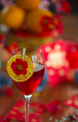 Chinese New Year party table in red and gold theme with food, drinks and decorations