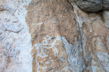 Lake Baikal. Rock paintings of ancient archer hunter on a horse on the famous Sagan-Zaba rock. Tourist attraction