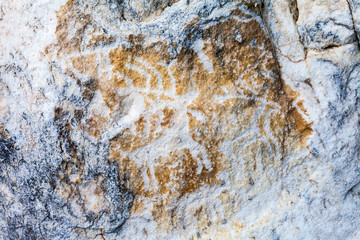 Lake Baikal. Ancient rock carvings of deers on the famous Sagan-Zaba rock. Tourist attraction