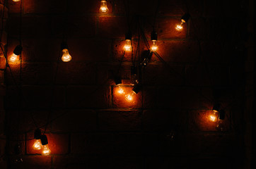 Concept vintage bulbs on brick wall background
