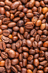 Roasted coffee beans on a dark slate for texture and background