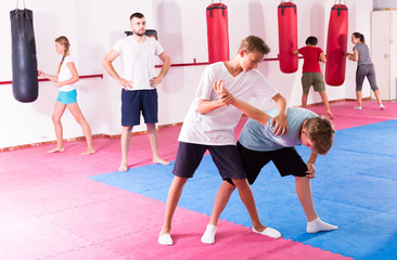 Fototapeta premium Kids practicing in pair self-protection