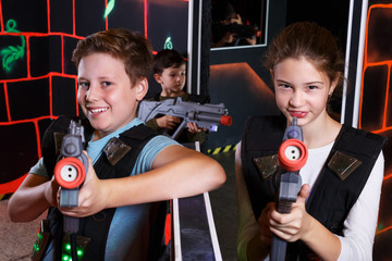 Girl and boy playing laser tag