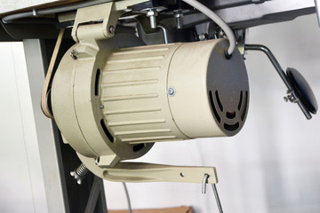 Sewing machine on table in tailor's workshop