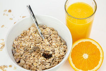 Balanced breakfast with muesli bowl and fresh orange juice