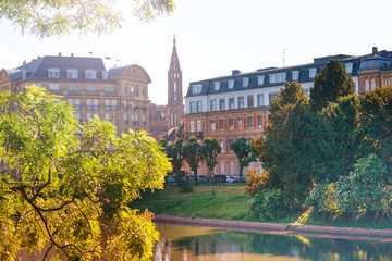 Ill river embankment and Strasbourg Cathedral, France