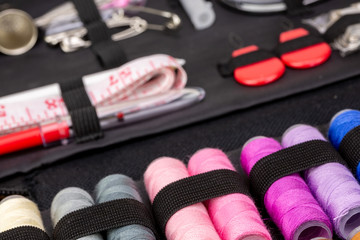 Group of colorful spools of thread used to sewing, needlework and embroidery over bright yellow background
