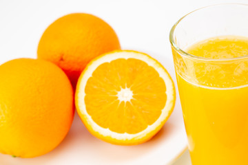 fresh orange juice and half orange isolated on white background