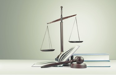 Justice Scales, gavel and books on light background