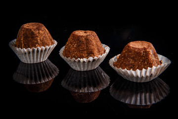 closeup row of three healthy useful organic handmade chocolate candies