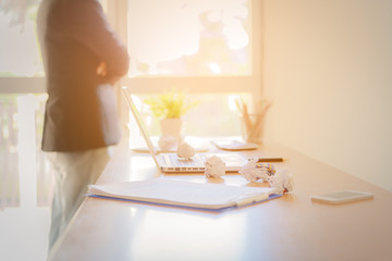 Business man working at office with laptop, tablet and graph data documents on his desk.