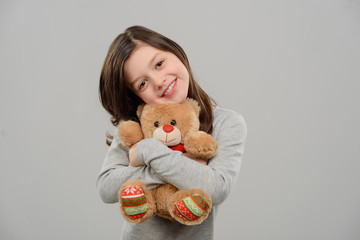 Girl hugging a Teddy bear