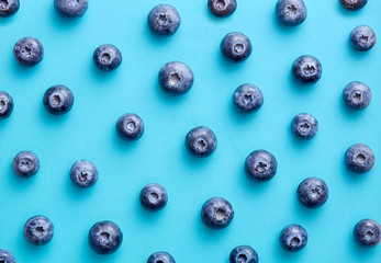 Blueberry pattern on a blue background viewed from above. Top view.