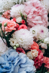 A beautiful bouquet from blue, red, white and pink flowers for decorating festive decor. Natural concept