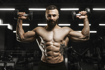 Fototapeta na wymiar Handsome strong athletic men pumping up muscles workout bodybuilding concept background