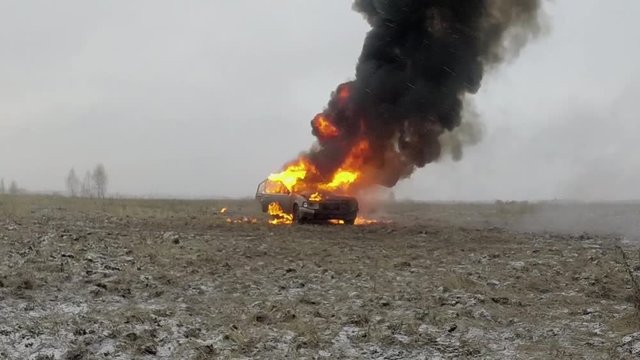 Car Explosion, Car burns in a gray field