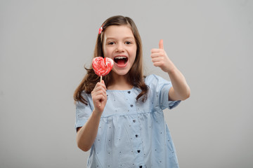 Girl showing a lollipop